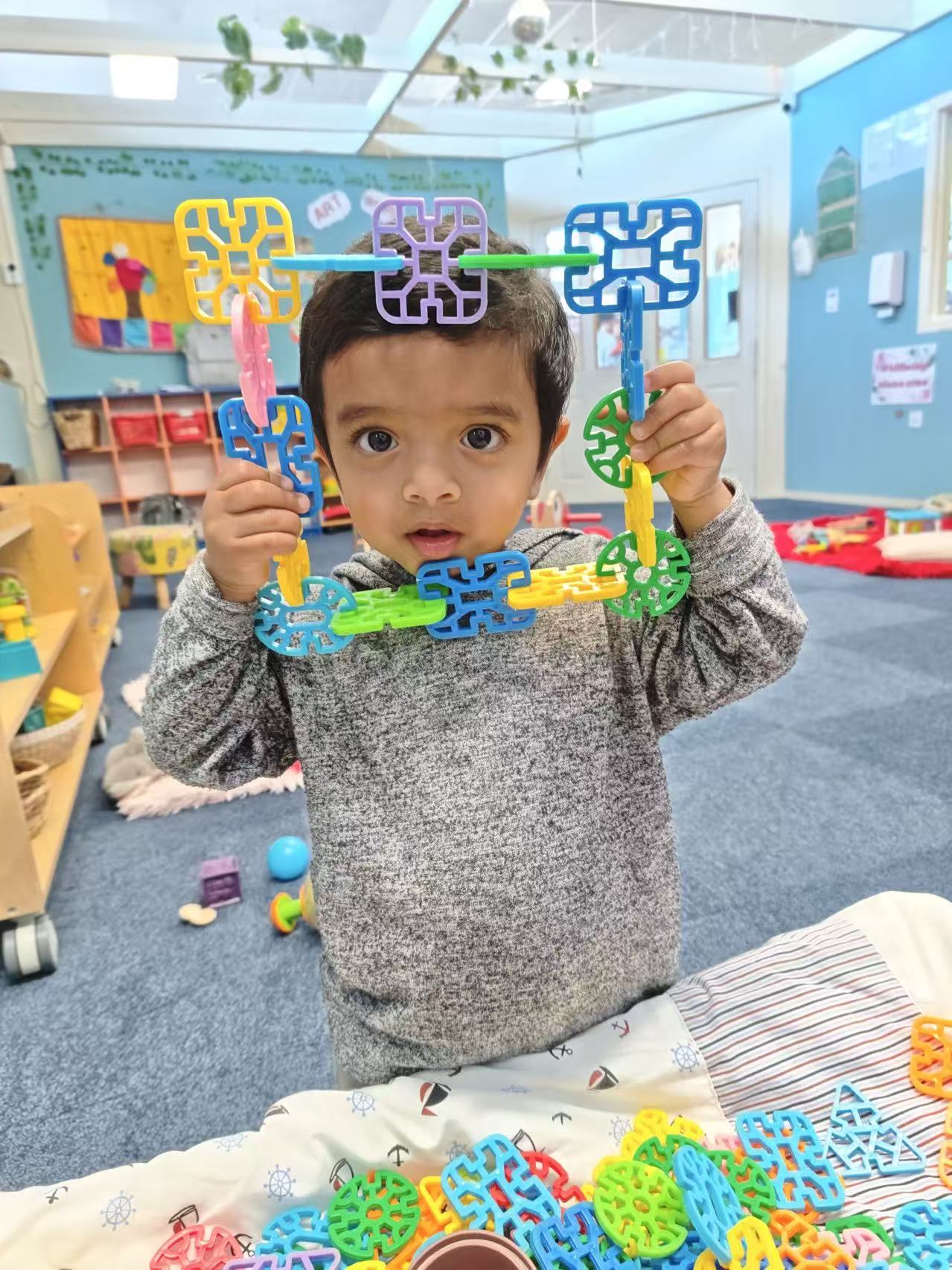 Child building with colourful construction pieces
