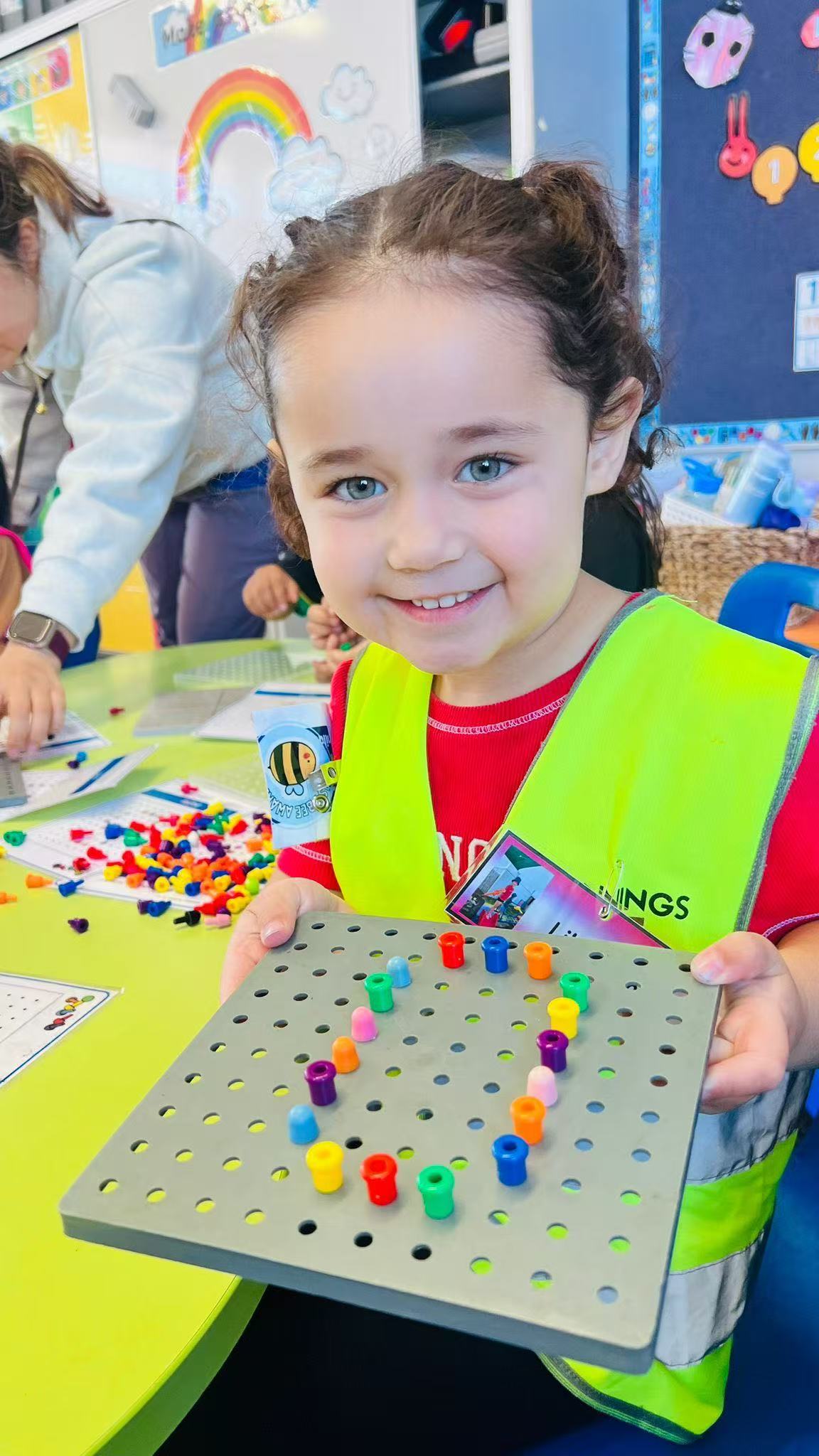 Child completing a peg board fine motor activity