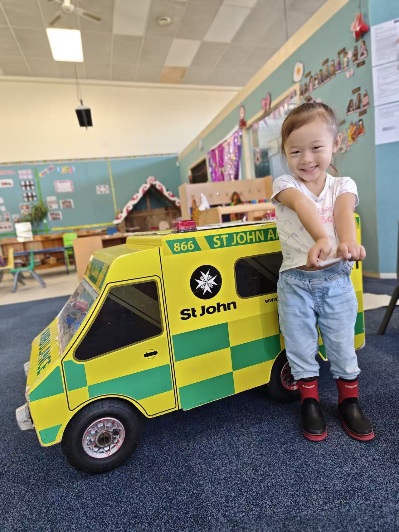 Child standing beside a St John learning resource